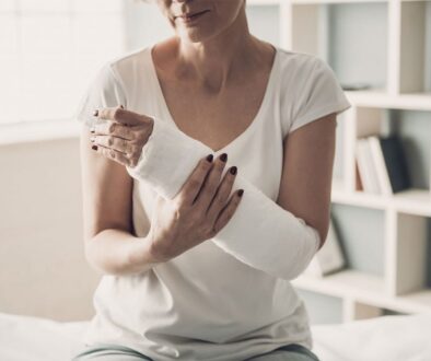 Woman holding hand following surgery.