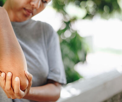 Closeup Of A Woman Holding Her Elbow Experiencing Elbow Pain When Bending