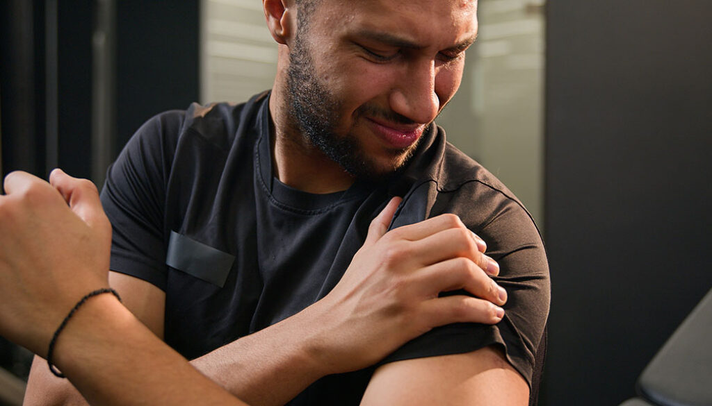 Closeup Of An African American Man Holding His Shoulder In Pain What Causes A Separated Shoulder