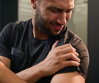 Closeup Of An African American Man Holding His Shoulder In Pain What Causes A Separated Shoulder