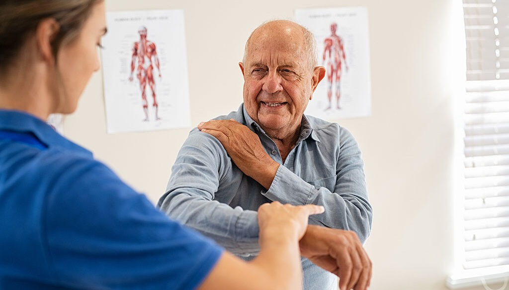 A Physical Therapist Assisting A Senior Man With A Shoulder Movement During Labrum Tear Recovery